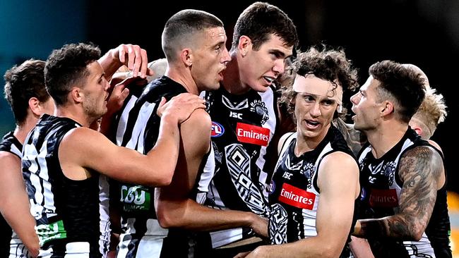 Pie players get around American big man Mason Cox after his inspirational goal. Picture: Getty Images