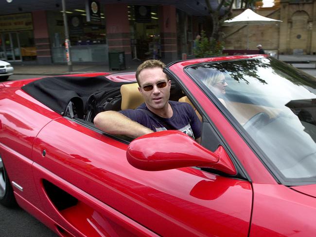 Michael Slater driving a Ferrari 355 motor car in Sydney in 2002.