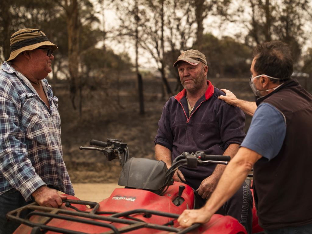 Beef farmer Steve Shipton (centre) is consoled by fellow farmers Bernie Smith (left) and Peter Mercieca in Coolagolite, NSW on New Year’s Day. Picture: Sean Davey/AAP