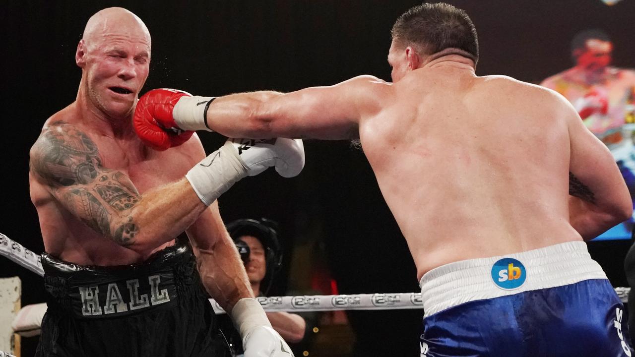 Paul Gallen lands a jab on Barry Hall’s chin at Margaret Court Arena in Melbourne.