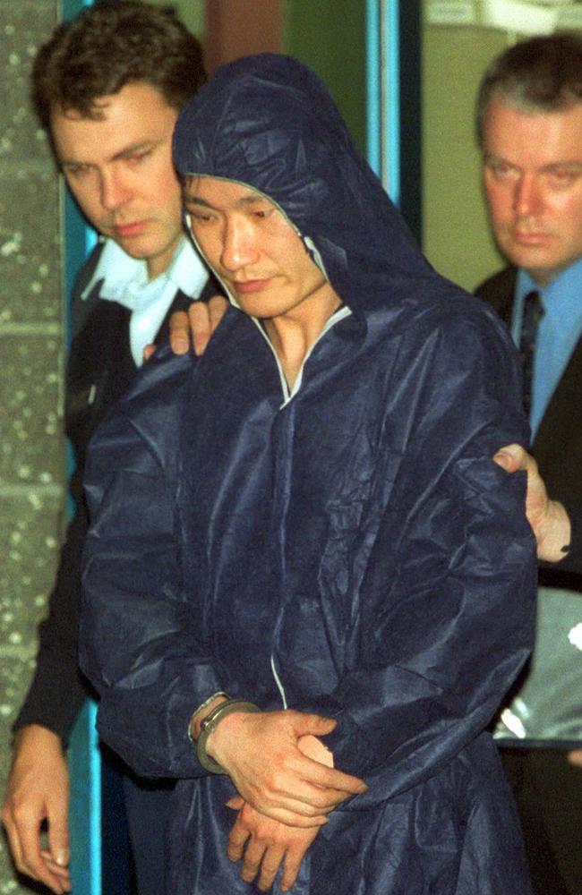 Huan Yun Xiang wears a forensic suit after his arrest. Picture: Mark Smith