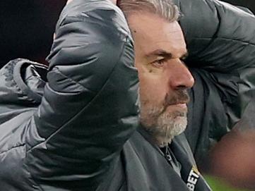 LIVERPOOL, ENGLAND - FEBRUARY 06: Ange Postecoglou, Manager of Tottenham Hotspur, reacts as Arne Slot, Manger of Liverpool, watches on during the Carabao Cup Semi Final Second Leg match between Liverpool and Tottenham Hotspur at Anfield on February 06, 2025 in Liverpool, England. (Photo by Carl Recine/Getty Images)