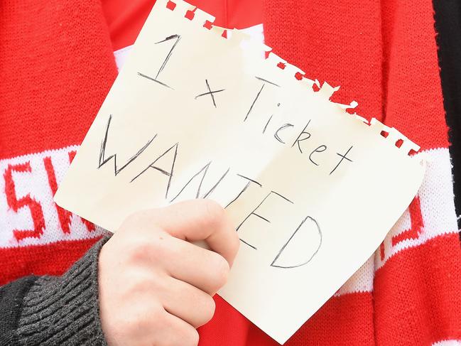 MELBOURNE, AUSTRALIA - OCTOBER 01:  A fan searches for tickets before the 2016 AFL Grand Final match between the Sydney Swans and the Western Bulldogs at Melbourne Cricket Ground on October 1, 2016 in Melbourne, Australia.  (Photo by Quinn Rooney/Getty Images)