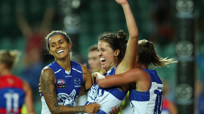 Kangaroos swamp Courteney Munn after she booted one of her matchwinning four goals. Picture: Getty Images