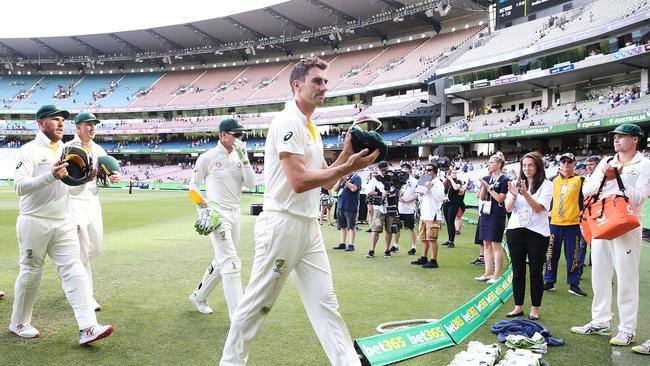 Pat Cummins is clapped off after his four-wicket spell late on day three. Picture: Getty