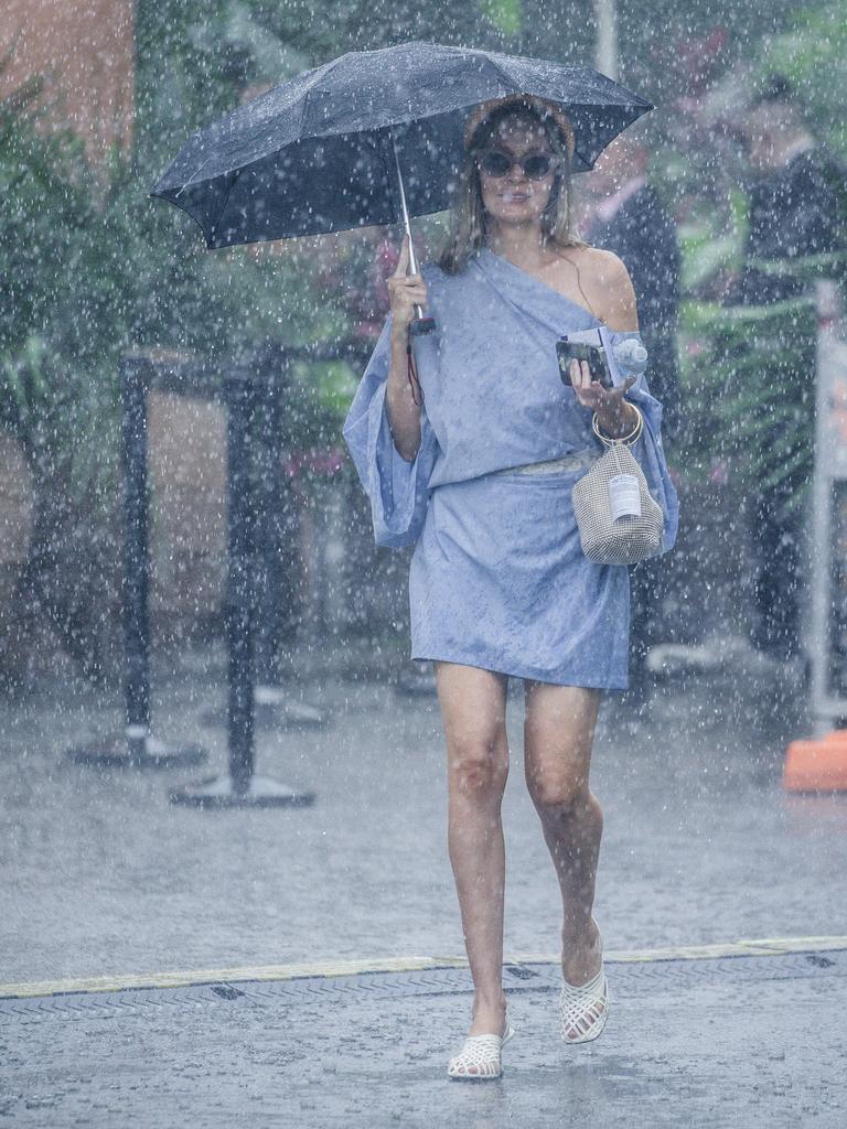 Heavy showers hit as Lili Peak was enjoying the Magic Millions Race Day. Picture: Glenn Campbell