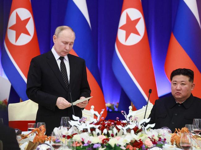 TOPSHOT - In this pool photograph distributed by the Russian state agency Sputnik, Russian President Vladimir Putin (L) speaks as North Korean leader Kim Jong Un listen during a reception at the Mongnangwan Reception House in Pyongyang on June 19, 2024. Putin enjoyed a red carpet welcome, a military ceremony and an embrace from North Korea's Kim Jong Un during a state visit to Pyongyang where they both pledged to forge closer ties. (Photo by Vladimir Smirnov / POOL / AFP) / -- Editor's note : this image is distributed by the Russian state owned agency Sputnik --