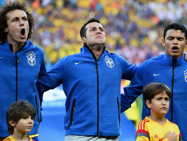 Brazil stars David Luiz (L), Julio Cesar and Thiago Silva (R) sing the national anthem before the 2014 FIFA World Cup Brazil Group A match against Croatia.