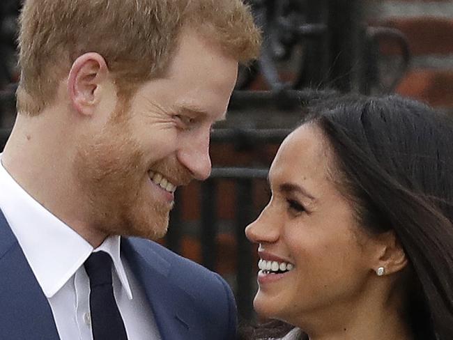 FILE - In this file photo dated  Monday Nov. 27, 2017, Britain's Prince Harry and his fiancee Meghan Markle pose for photographers in the grounds of Kensington Palace in London, following the announcement of their engagement. Speculation is mounting over who will be invited to the May 19, 2018, royal wedding of Prince Harry and Meghan Markle, with some high profile people openly saying they would like to attend, though the actual guest list is a closely guarded secret.   (AP Photo/Matt Dunham, FILE)