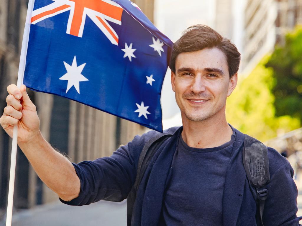 An AI-generated image of a man holding an Australian flag. Picture: Firefly