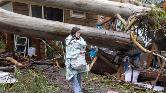 A girl walks from her destroyed home after the storm. Picture: David Geraghty