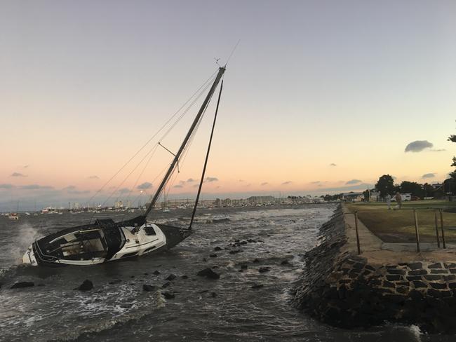 A yacht left on rocks near Williamstown after the strong winds hit the state last night. Picture: Amalia Benic