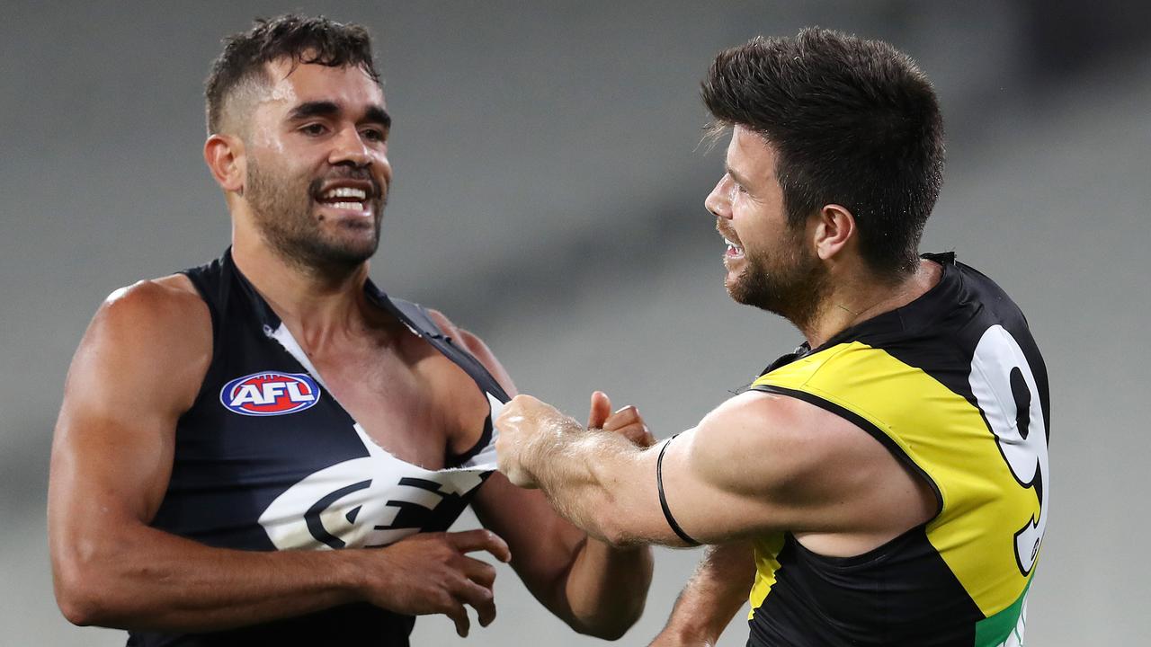 Jack Martin tangles with Richmond captain Trent Cotchin during his Carlton debut. Picture: Michael Klein.