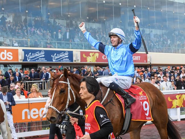 Michael Dee returns to the mounting yard on Durston (GB) after winning the Carlton Draught Caulfield Cup at Caulfield Racecourse on October 15, 2022 in Caulfield, Australia. (Photo by Brett Holburt/Racing Photos via Getty Images)