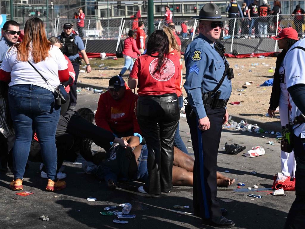 An injured person is helped near the Kansas City Chiefs' Super Bowl LVIII victory parade in Kansas City, Missouri. Picture: AFP