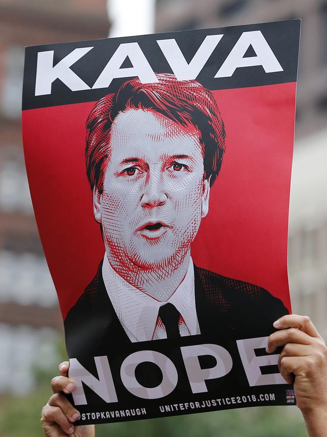 A protester holds a sign in opposition to Judge Brett Kavanaugh at a rally at City Hall in Boston. Picture: AP