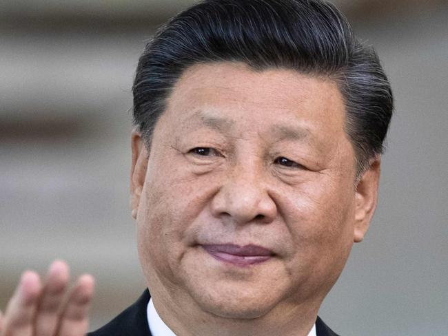 China's President Xi Jinping waves the press before the 11th BRICS Summit at the Itamaraty palace on November 14, 2019 in Brasilia, Brazil. - Brazil's President Jair Bolsonaro walked a diplomatic tightrope, as he seeks to boost ties with Beijing and avoid upsetting key ally Donald Trump, on the eve of a summit with their BRICS counterparts from Russia, India and South Africa. (Photo by Pavel Golovkin / POOL / AFP)