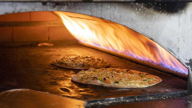 Mina’s wood-fired oven in action. Picture: Matthew Vasilescu