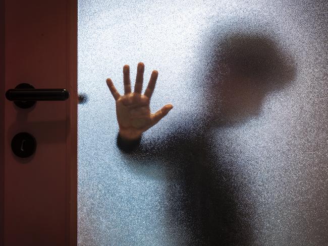 Blurred sad boy leaning open hand against glass door. TSS (The Southport School) stock photo. Photo: iStock