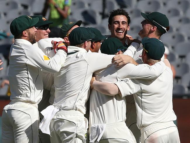 Players swamp Starc after he cleaned up the tail. Picture: Wayne Ludbey