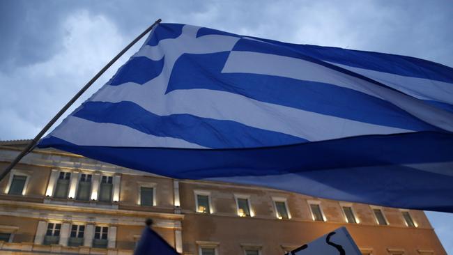 Demonstrators gather during a rally organized by supporters of the YES vote for the upcoming referendum in front of the Greek Parliament in Athens, Tuesday, June 30, 2015. At midnight central Europe-time on Tuesday, the country is set to become the first developed nation to miss a debt repayment to the International Monetary Fund, as Greece sinks deeper into a financial emergency that has forced it put a nationwide lockdown on money withdrawals. (AP Photo/Petros Karadjias)