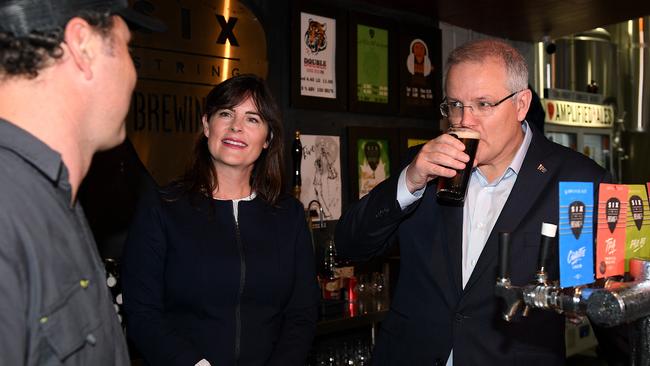 Scott Morrison has a beer yesterday morning during a visit with Liberal MP Lucy Wicks to Six Strings Brewery in Erina. Picture: AAP