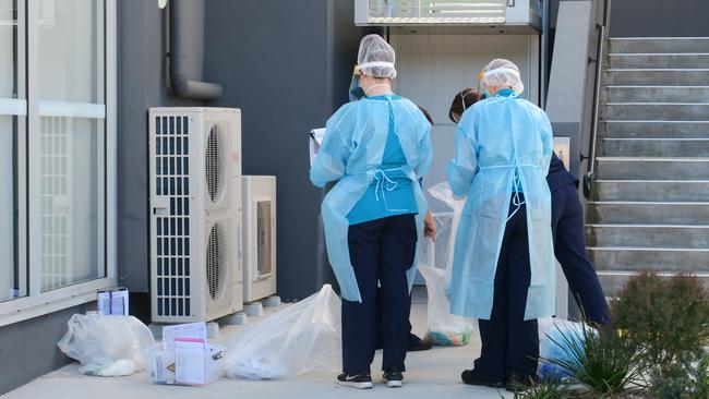 NSW Health workers conducting Covid tests at a unit block at Sturt Rd, Cardiff. Picture: Emily Burley.