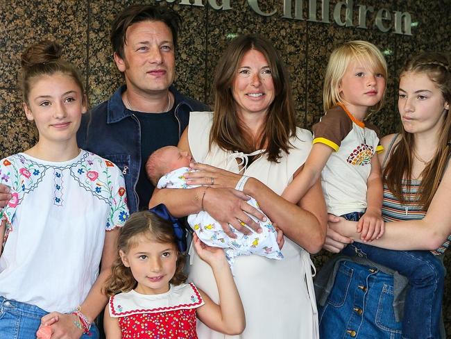 Jamie and Jools Oliver pose with their new yet-to-be-named baby boy, along with his siblings (l-r) Daisy Boo Pamela, Petal Blossom Rainbow, Buddy Bear Maurice and Poppy Honey Rosie. Picture: Getty