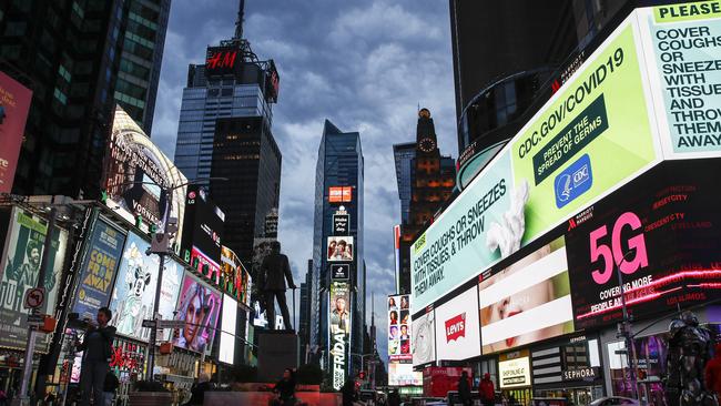 Virus-safe messages in a quiet Times Square, New York. (AP Photo/John Minchillo, File)