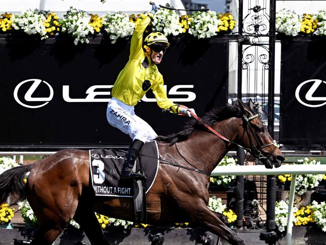 TOPSHOT - Jockey Mark Zahra celebrates winning on Without A Fight in the 6 million USD Melbourne Cup horse race at the Flemington Racecourse in Melbourne on November 7, 2023. (Photo by William WEST / AFP) / --IMAGE RESTRICTED TO EDITORIAL USE - STRICTLY NO COMMERCIAL USE--