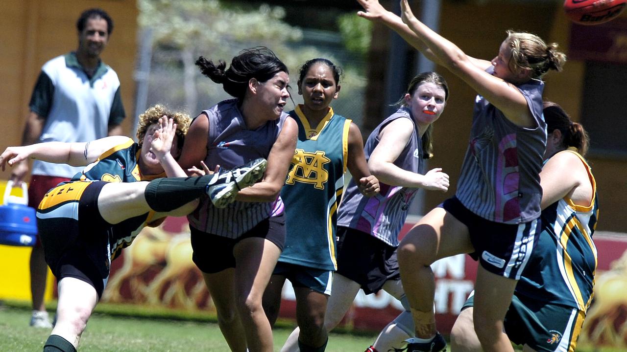 A pack of Katherine players can't smother Stacey Lovell ripping kick up front for St Marys