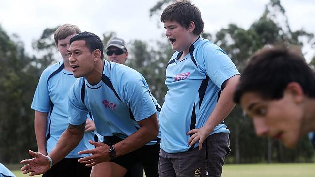 Israel Folau imparts some tips during a visit to St Columban’s College in Queensland.