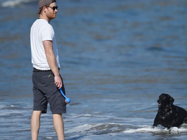 *** FEES APPLY. ONE TIME USE ONLY. FOR PRINT & ONLINE. MUST CREDIT GAC/MEGA TheMegaAgency.com ** ** PREMIUM EXCLUSIVE: Prince Harry goes barefoot on the beach while playing fetch with his black lab in the the American Riviera's Pacific Ocean in Santa Barbara. Casually-dressed in blue cargo shorts, a t-shirt, shades and back-to-front baseball cap, Harry looked to have not a care in the world as he enjoyed an afternoon stroll, with only his personal security and lab 'Pula' for company. With the beach near deserted, there was no need to cover up with a face mask. Animal lovers Harry, 36, and Meghan, 39, welcomed Pula into their home shortly after their May 2018 wedding, joining Meghan's rescue beagle Guy. And the dog's name has special meaning Ã¢â‚¬â€&#157; Pula is the official currency of Botswana, the country in Africa where Harry took Meghan when they first started dating. Pula means "rain" in Setswana Ã¢â‚¬â€ and since rain is very scarce in Botswana, it's considered valuable and a blessing. Pula also made an appearance during Meghan and Prince Harry's controversial interview with Oprah Winfrey. The couple shared a new video of their family Ã¢â‚¬â€ including son Archie, who will turn 2 in May Ã¢â‚¬â€ enjoying time at the beach. During the Oprah interview, Meghan and Harry, who announced they are expecting a baby girl this summer, opened up about their move to Santa Barbara and how it has benefitted Archie. 31 Mar 2021 Pictured: Prince Harry goes barefoot on the beach while playing fetch with his black lab in the Pacific Ocean. Photo credit: GAC/MEGA TheMegaAgency.com +1 888 505 6342 (Mega Agency TagID: MEGA743655_001.jpg) [Photo via Mega Agency]