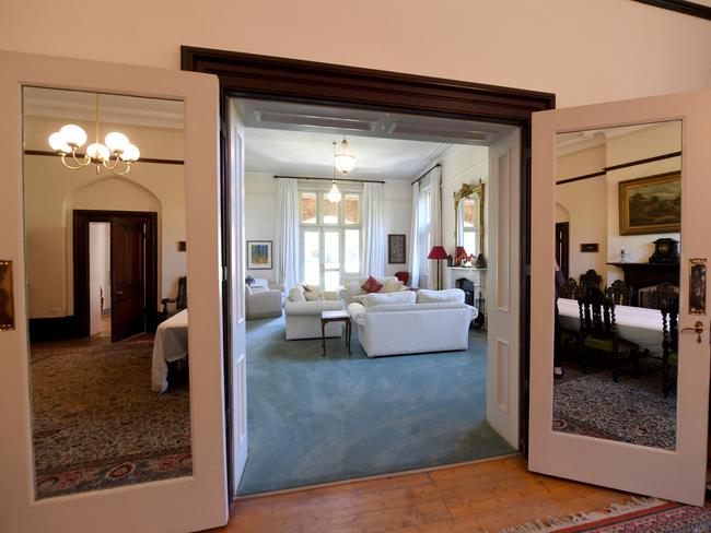 Archbishop Geoffrey Smith at Bishop's Court North Adelaide which is being put up for sale by the church. The drawing room or lounge room, looking in from the main dining room. Picture: Tricia Watkinson