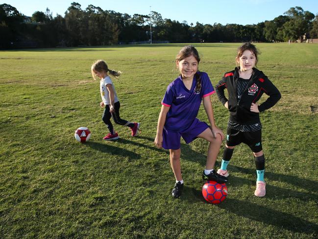 06/05/2020. Olaia Bello 7 (C) , Scarlet Hall 7 (R)and Ariela Bello 5. Members of the Under 8's Putney Rangers Football Club at Morrison Bay Park in Putney in Western Sydney. Local sporting clubs are hoping to get their kids back on the field after the government announces an easing of COVID-19 restrictions later this Friday. Britta Campion/The Australian