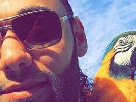 Rachad Alameddine taking a selfie with a bird on his shoulder. Picture supplied