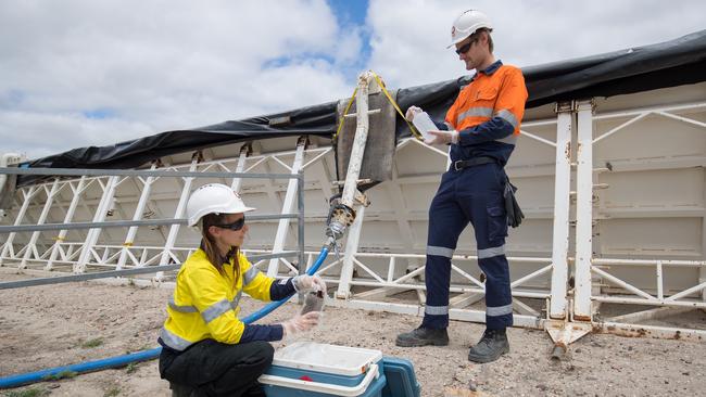 CSIRO scientists Adelle Semmler and Josh King collect water samples at a CSG well site. Picture: Supplied