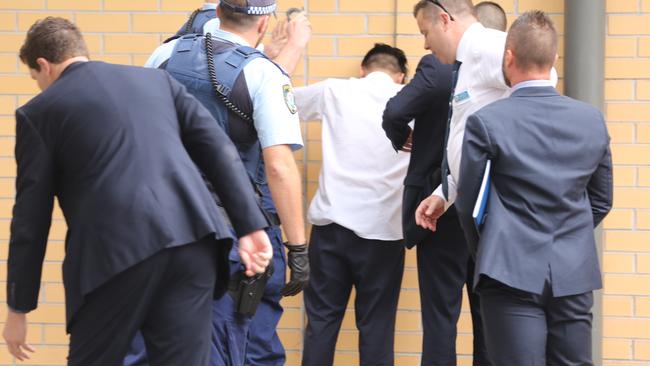 Police arrest a school student outside an ALDI store near Bonnyrigg High School Picture: John Grainger