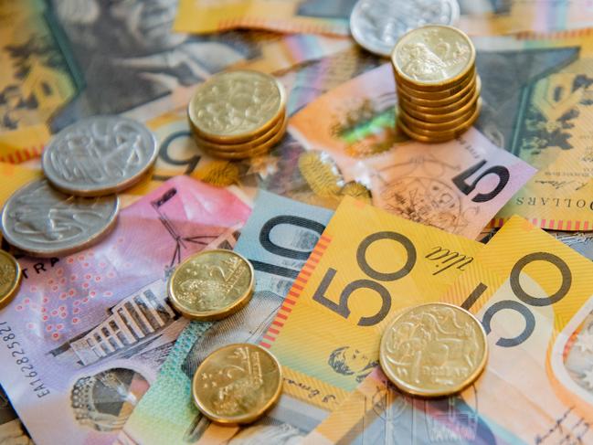 Australian notes and coins spilled out on a table