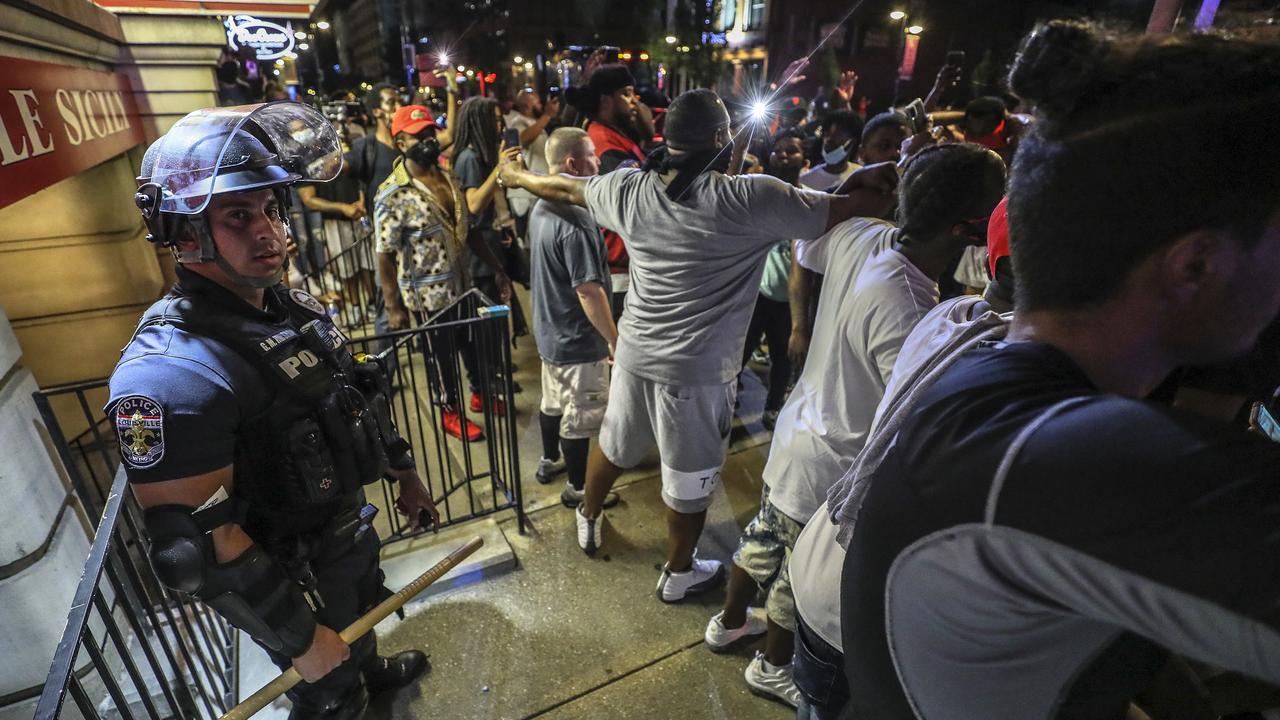 Protesters surround a police officer in Louisville, Kentucky on May 28 during a protest for Breonna Taylor, a black woman fatally shot by police in her home in March. Picture: Michael Clevenger/Courier Journal via AP