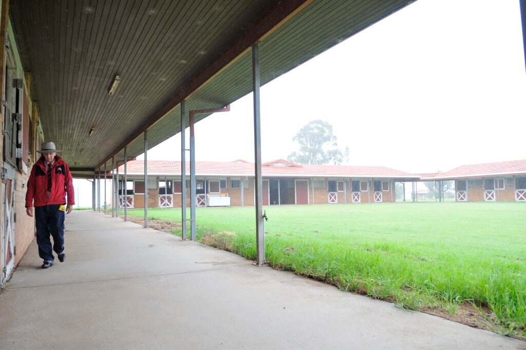 Elders Toowoomba rural sales consultant Bob Loiterton walks by some of the brick buildings set to go to the highest bidder in March. Picture: Dave Noonan