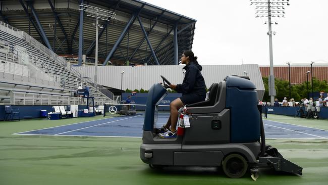 A member of the grounds crew dries an outside court at Flushing Meadows. Picture: Getty Images