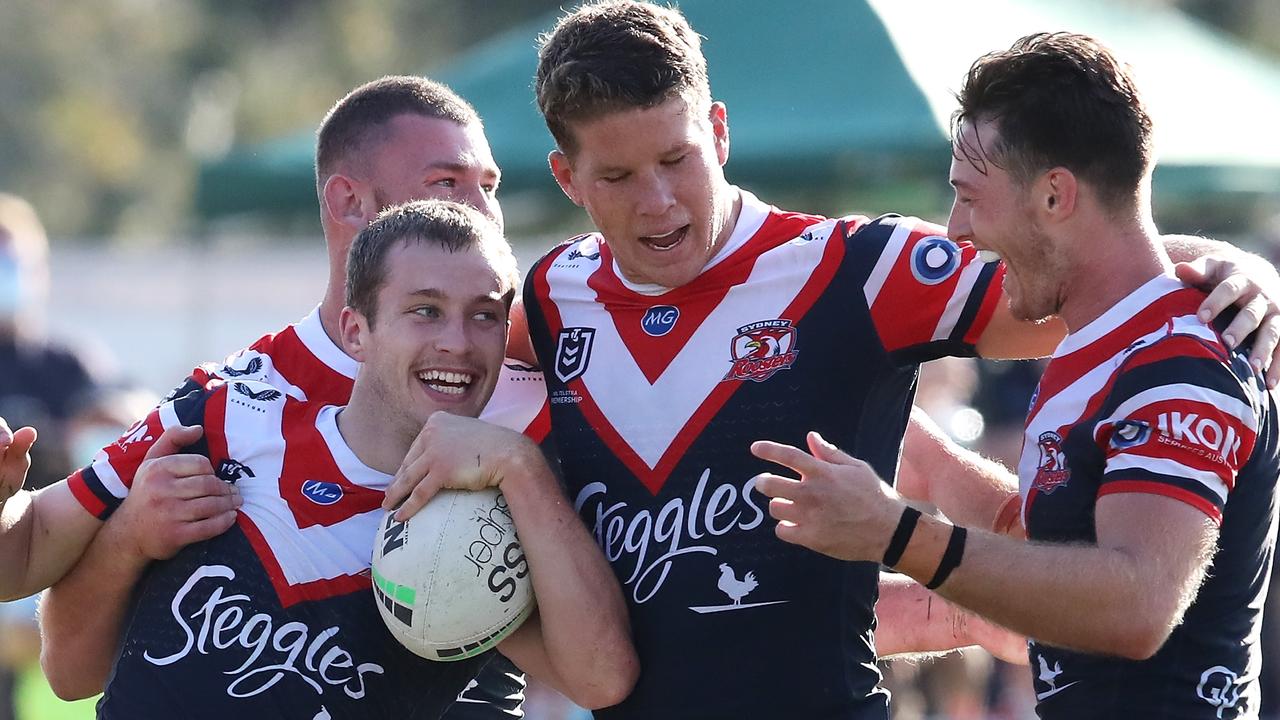 TOOWOOMBA, AUSTRALIA - AUGUST 22: Sam Walker of the Roosters celebrates with his team mates Fletcher Baker, Egan Butcher and Sam Verrills after scoring a try during the round 23 NRL match between the St George Illawarra Dragons and the Sydney Roosters at Clive Berghofer Stadium, on August 22, 2021, in Toowoomba, Australia. (Photo by Jono Searle/Getty Images)