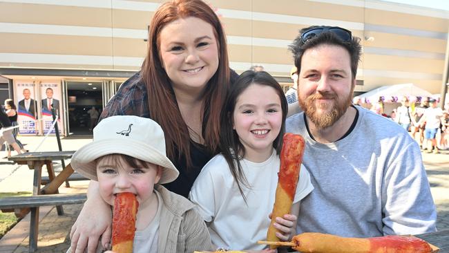 Hudson, 4, Emily Lock, Ava, 9, and Andrew Lock enjoying dagwood dogs at the Royal Adelaide Show. Picture: Keryn Stevens