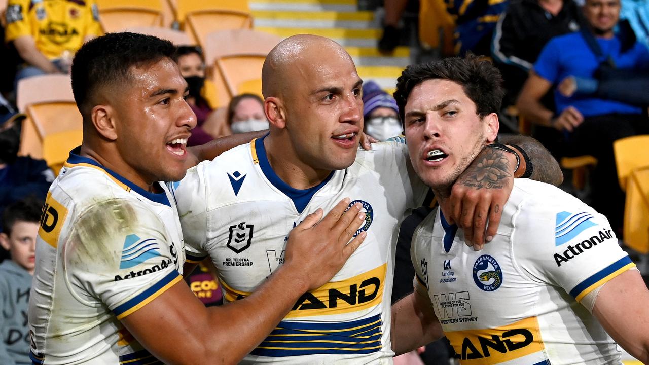 BRISBANE, AUSTRALIA - AUGUST 28: Blake Ferguson of the Eels is congratulated by team mates after scoring a try during the round 24 NRL match between the Melbourne Storm and the Parramatta Eels at Suncorp Stadium, on August 28, 2021, in Brisbane, Australia. (Photo by Bradley Kanaris/Getty Images)
