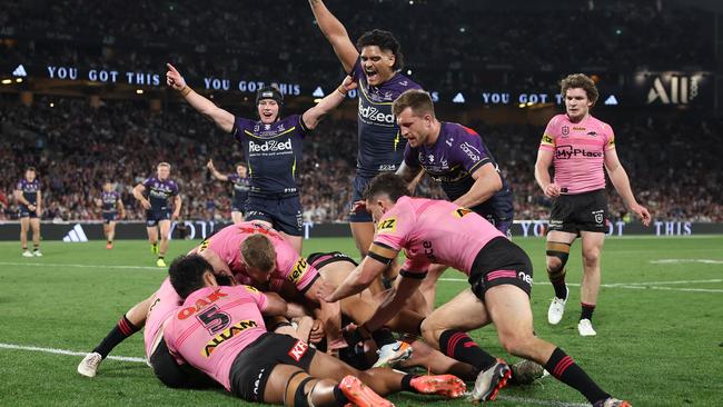 SYDNEY, AUSTRALIA - OCTOBER 06:  Jack Howarth of the Storm is help up over the try-line during the 2024 NRL Grand Final match between the Melbourne Storm and the Penrith Panthers at Accor Stadium on October 06, 2024, in Sydney, Australia. (Photo by Cameron Spencer/Getty Images)