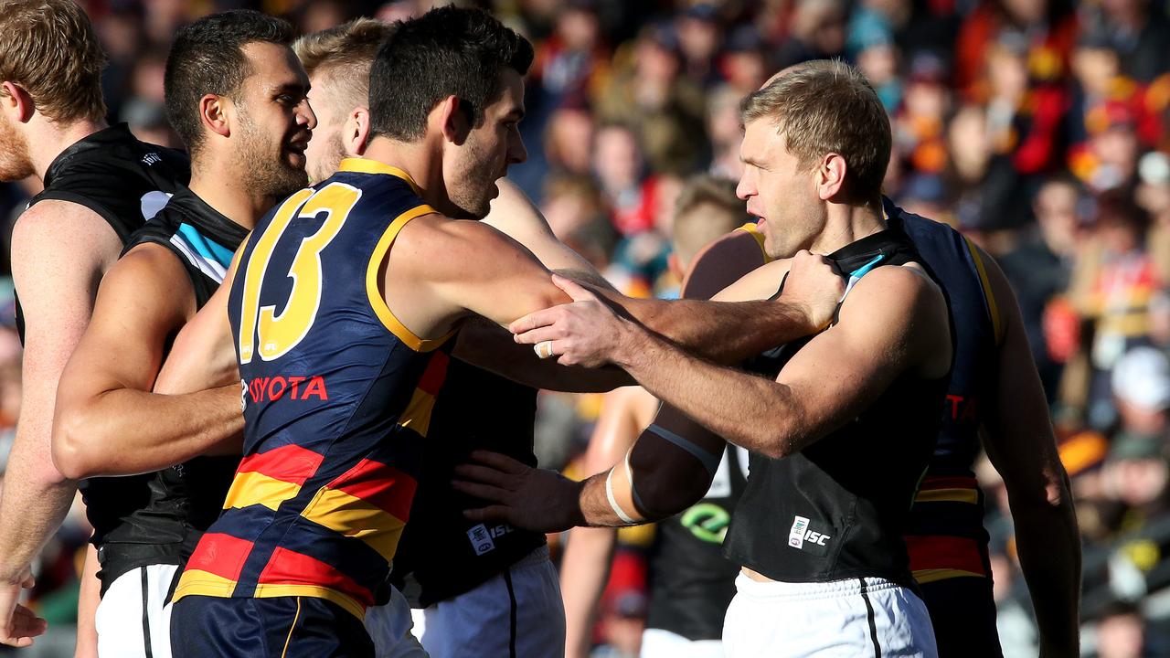 Taylor Walker and Kane Cornes have an on-field encounter during a 2014 Showdown. Photo: Simon Cross