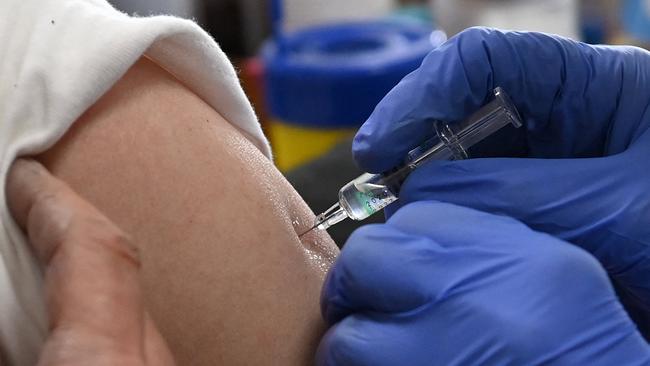 A local pensioner receives the first dose of the Russian vaccine against the novel coronavirus in her home doctor's office in Nagykata, Hungary, on February 24, 2021. - Hungary on February 24 became the first EU nation to start using China's coronavirus Sinopharm vaccine, Prime Minister Viktor Orban said. The country of 10 million has ordered around five million doses of the Chinese jab, and has already started inoculating its population with Russia's Sputnik V vaccine -- another EU first. (Photo by Tibor ILLYES / various sources / AFP)