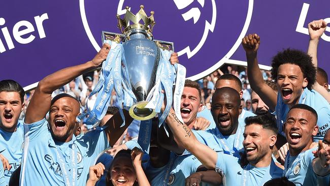 Man City players lift the trophy after winning the Premier League in 2018. Picture: AFP PHOTO / Paul ELLIS