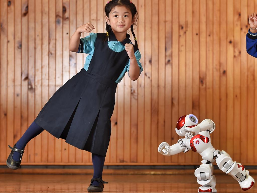 PREPS will use a humanoid robot to improve their speaking and listening skills. The 30cm- tall NAO robot is being programmed by grade 5 students at Glendal Primary School to interact with prep children. Prep students, Alivia and Eshan dance along with NAO's the robot. Picture: Tony Gough